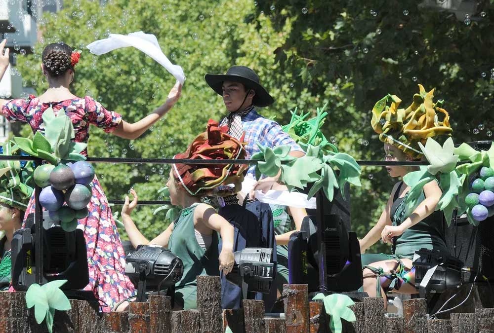 Folklore dancers dancing on one of the grape harvest floats.